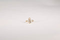 Gold ring with a diamond on a light gray background